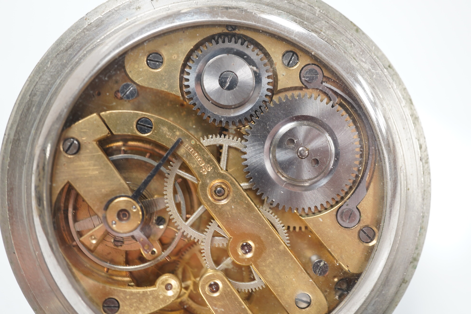 An Edwardian repousse silver mounted travelling watch case, maker W.?, Chester, 1902, 11.1cm, containing a nickel cased pocket watch. Condition - poor to fair